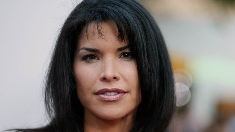 Lauren Sánchez Bezos smirking at the premiere of 'Hollywood Homicides,' wearing shiny lip gloss.
