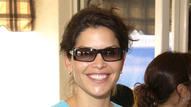 Lauren Sánchez Bezos smiling while wearing a light blue shirt and sunglasses.