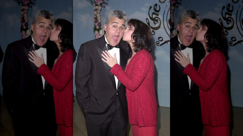 Jay Leno makes a shocked face as his wife, Mavis, plants a kiss on his cheek in front of the cameras