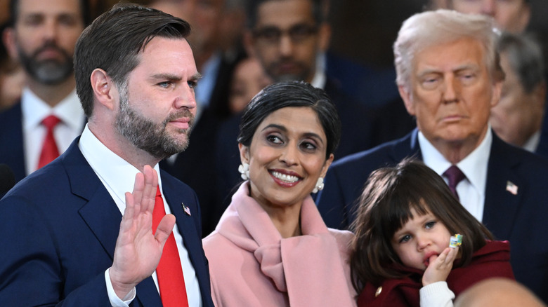 Usha Vance holding daughter while smiling at JD Vance