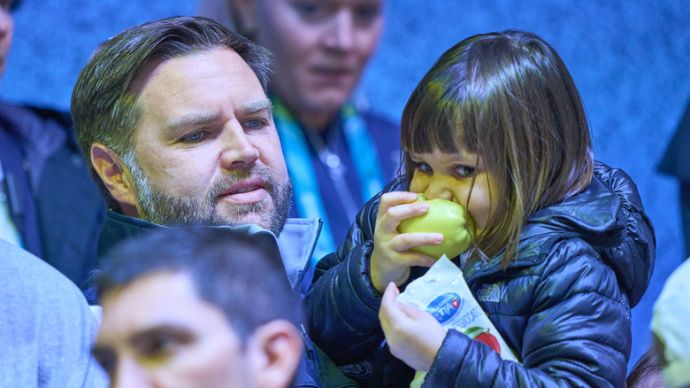 Mirabel Vance eating an apple next to JD Vance