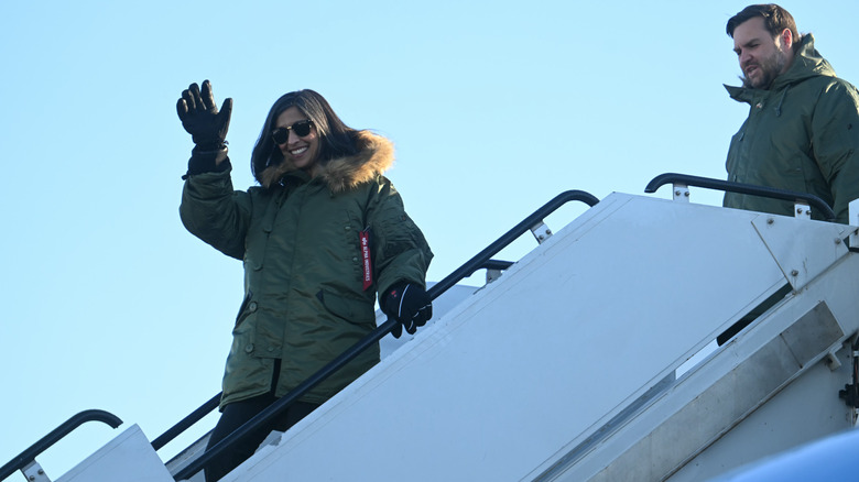Usha Vance walking ahead of JD Vance as they exit their plane in Greenland