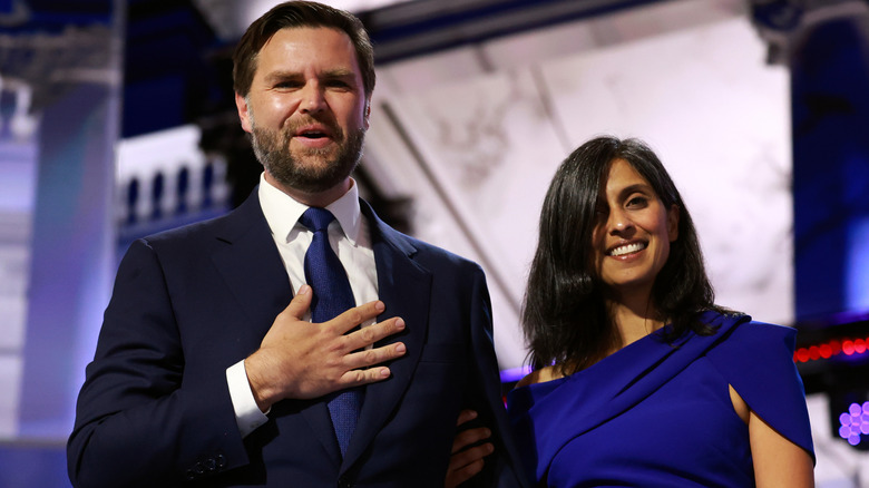 JD Vance and Usha Vance smiling in a suit and blue dress