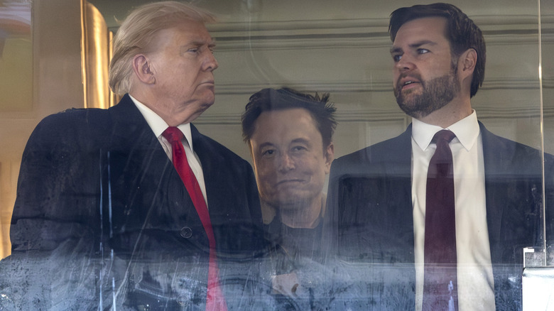 Donald Trump and JD Vance having a conversation with a smiling Elon Musk trying to wedge himself between them