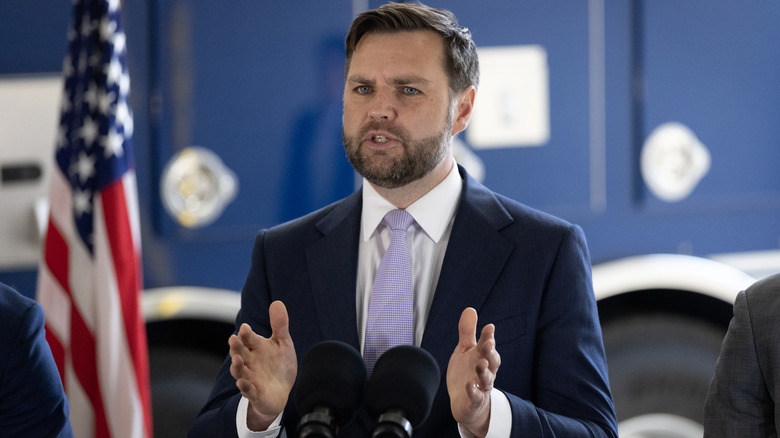 JD Vance at podium spreading hands apart