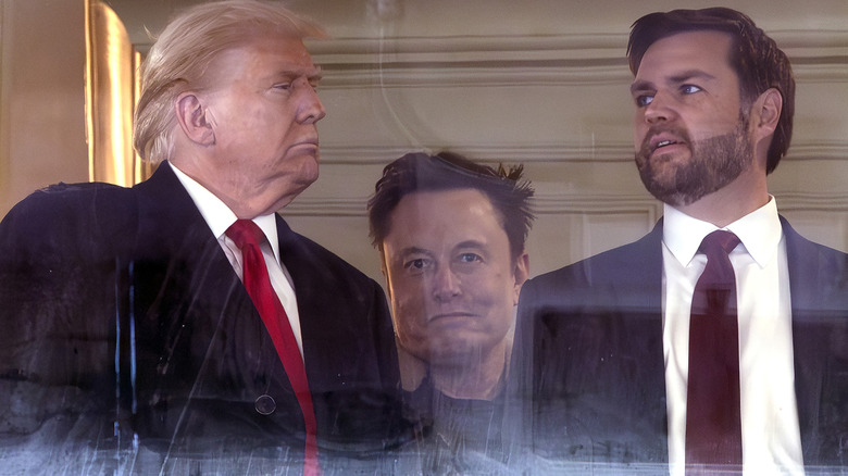 JD Vance and  Donald Trump speaking while Elon Musk is wedged between them