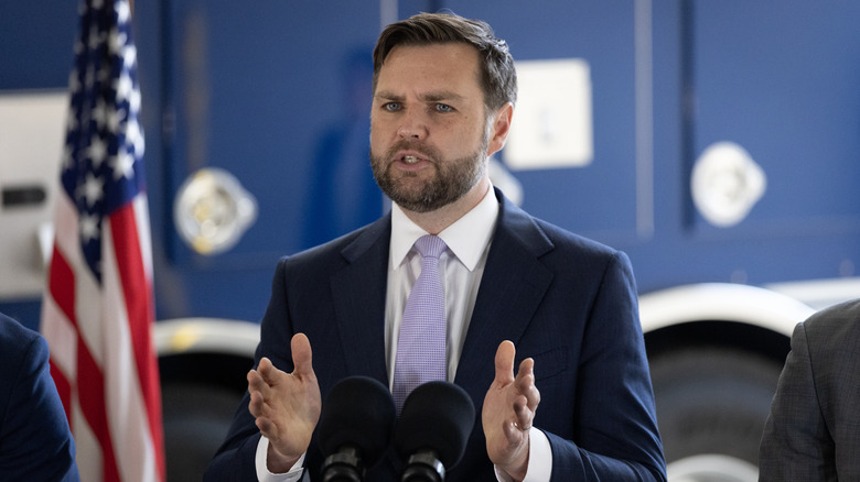 JD Vance speaks into two microphones