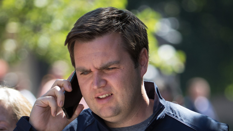 a beardless JD Vance talking on the phone