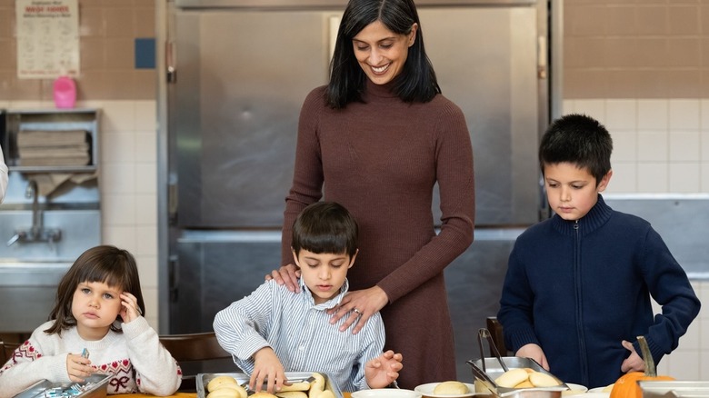 Usha Vance in mess hall with her children at serving trays