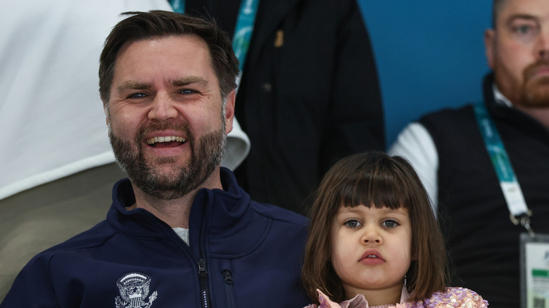 JD Vance smiling in bleachers at Olympics with his daughter Mirabel