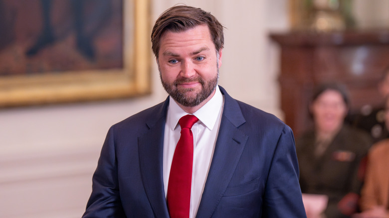JD Vance smiling in a blue suit