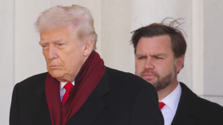 JD Vance walking behind Donald Trump