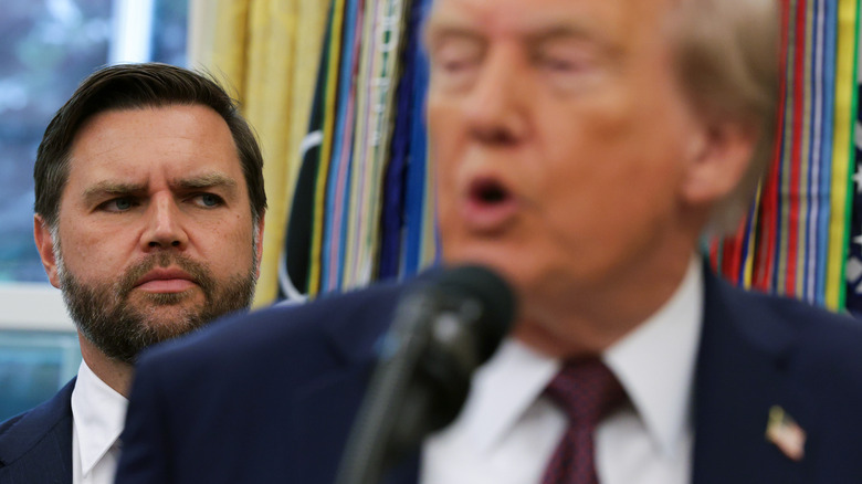 JD Vance standing behind Donald Trump as he speaks in the Oval Office