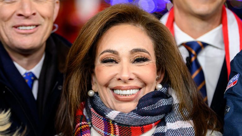 Jeanine Pirro smiling in a scarf