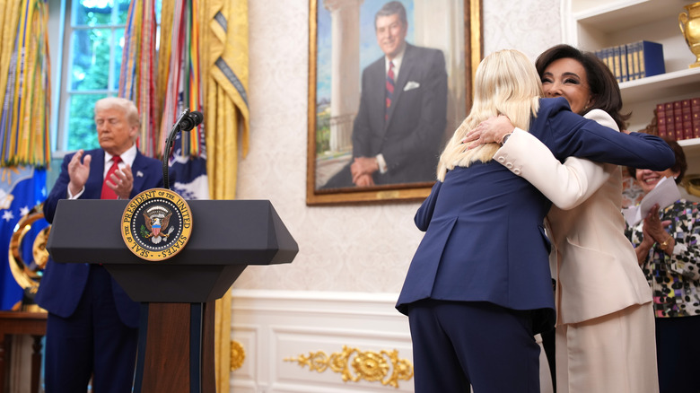 Pam Bondi and Jeanine Pirro hugging near Donald Trump