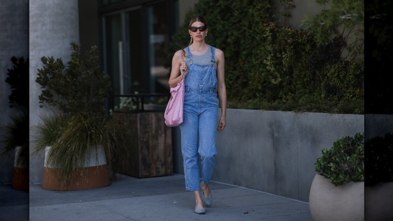 woman wearing overalls and tank top
