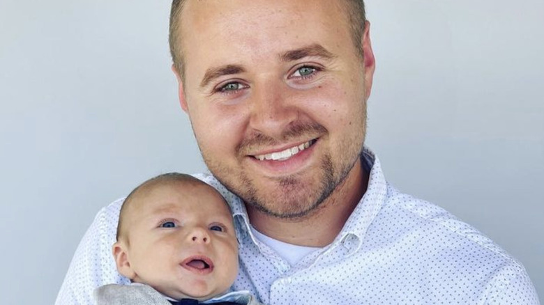 Jed Duggar holding his baby son