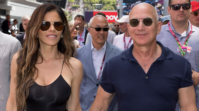 Lauren Sanchez and Jeff Bezos walking in sunglasses