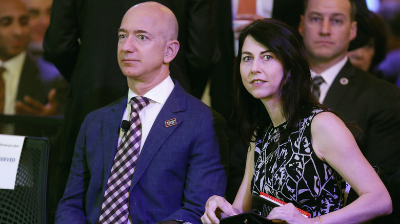 Mackenzie Scott and Jeff Bezos sitting at an event looking confused