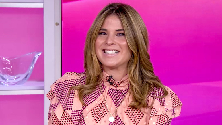 Jenna Bush Hager smiling in front of a pink background