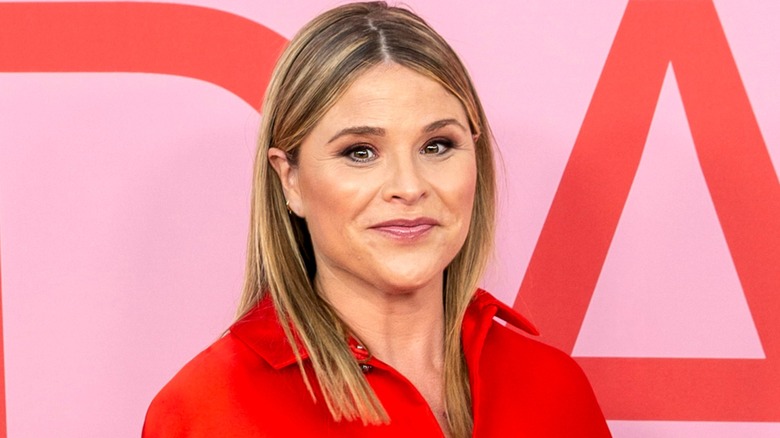 Jenna Bush Hager on the red carpet wearing a red shirt, and a face full of makeup