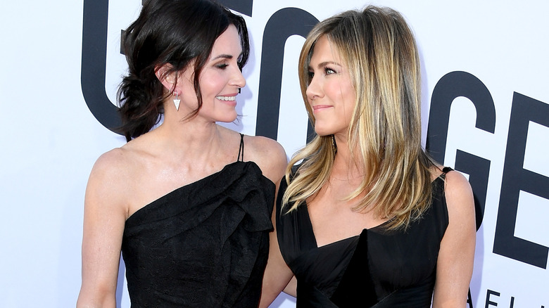 Jennifer Aniston and Courteney Cox looking at each other