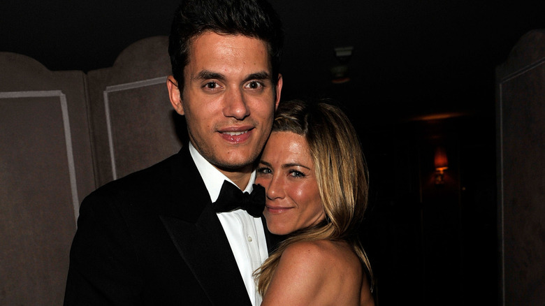 John Mayer and Jennifer Aniston posing at an award show