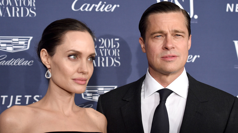 Angelina Jolie and Brad Pitt posing at a red carpet event in 2015