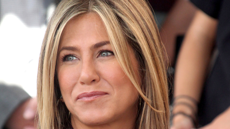 Jennifer Aniston smiles at an event.
