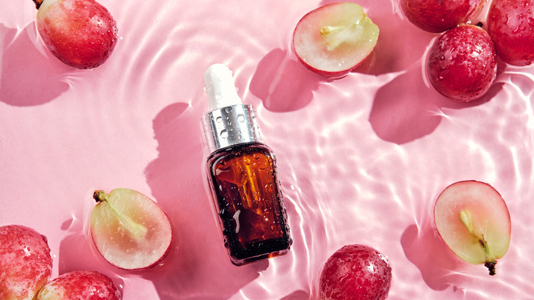 Face serum bottle pink background