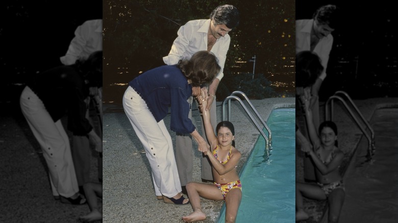 Young Jennifer Aniston in the pool beside parents Nancy Dow and John Aniston