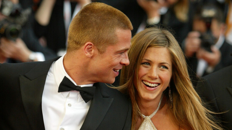 Jennifer Aniston and Brad Pitt laughing together at a Hollywood event