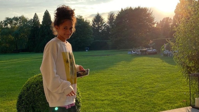 Emme Muñiz smiling in garden