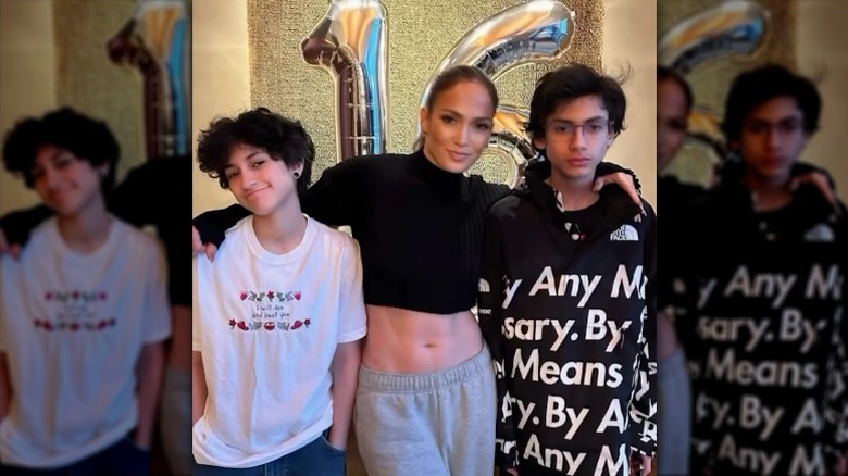 J.Lo with her arms around Emme and Max Muñiz in front of large "16" balloons