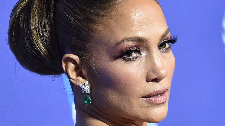 Jennifer Lopez posing with emerald earings