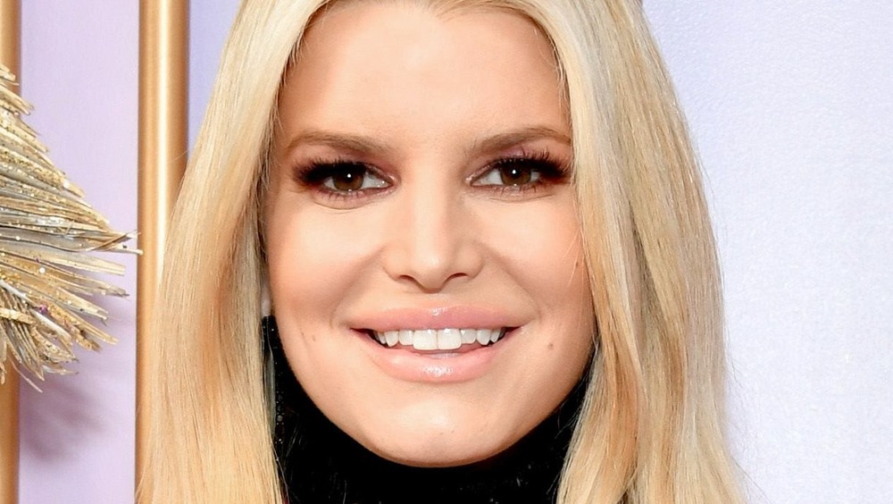 Jessica Simpson smiles in a black turtleneck