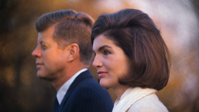 Jackie Kennedy standing beside JFK