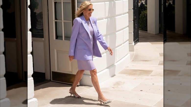 Jill Biden walking outside in purple suit in June 2024