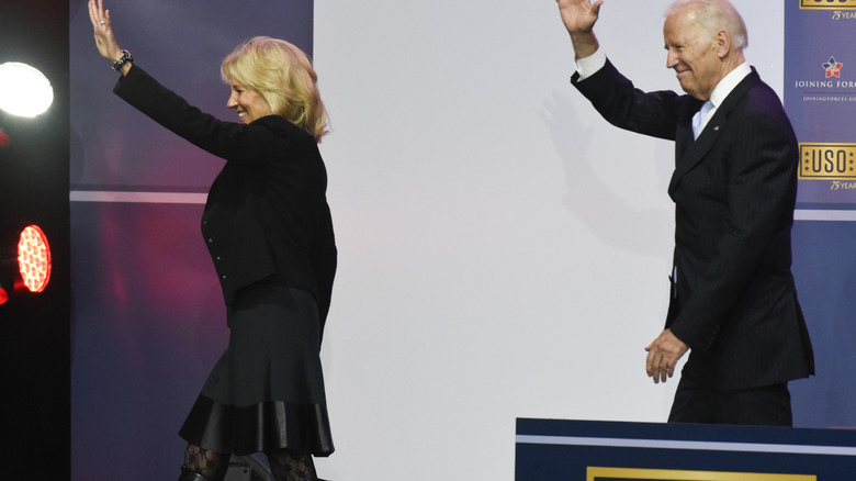 Jill Biden waving on stage in racy fishnet-adjacent tights