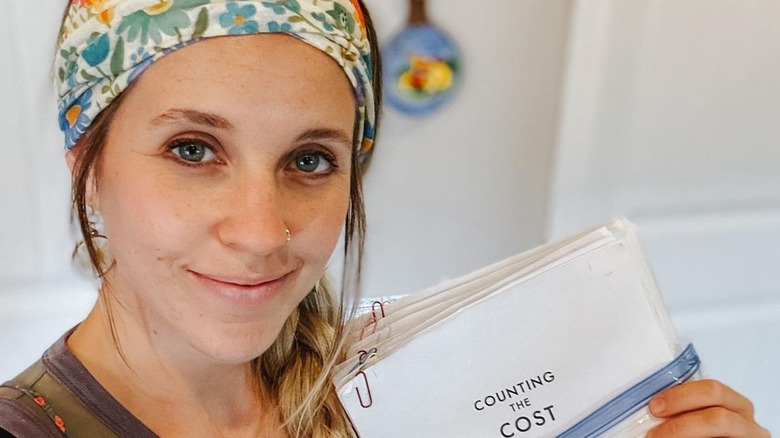 Jill Duggar holding book manuscript
