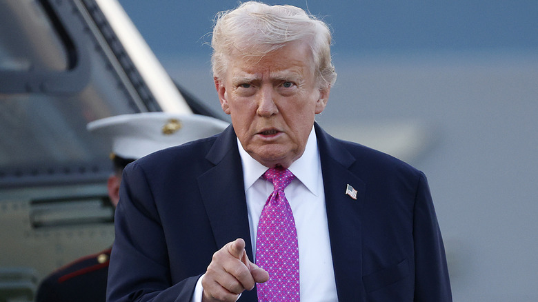 Donald Trump pointing while wearing pink tie