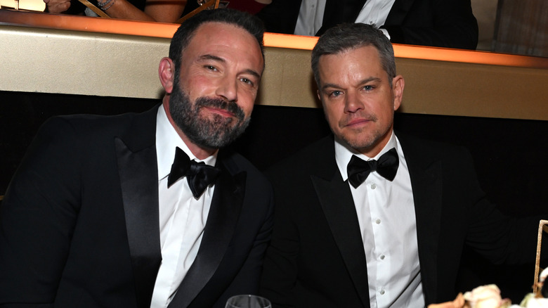 Ben Affleck and Matt Damon posing for photos in tuxedos