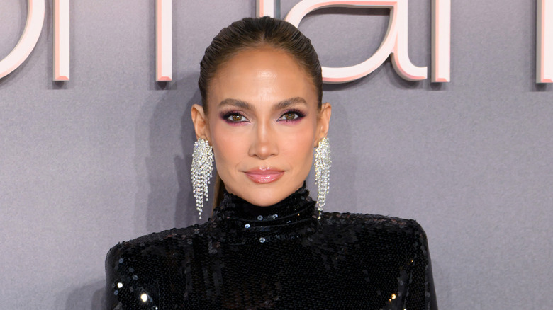 Jennifer Lopez posing on the red carpet in a sparkly black dress