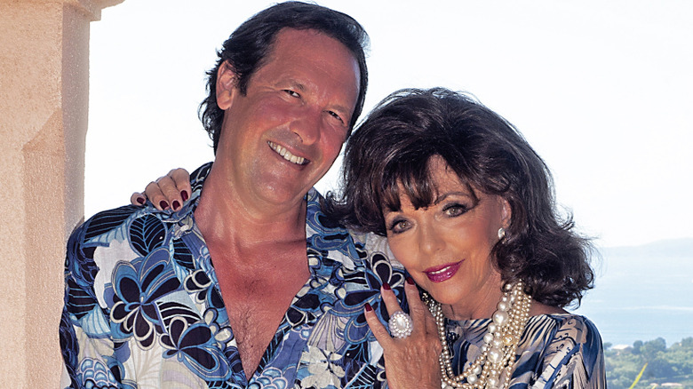 Percy Gibson and Joan Collins smiling outside