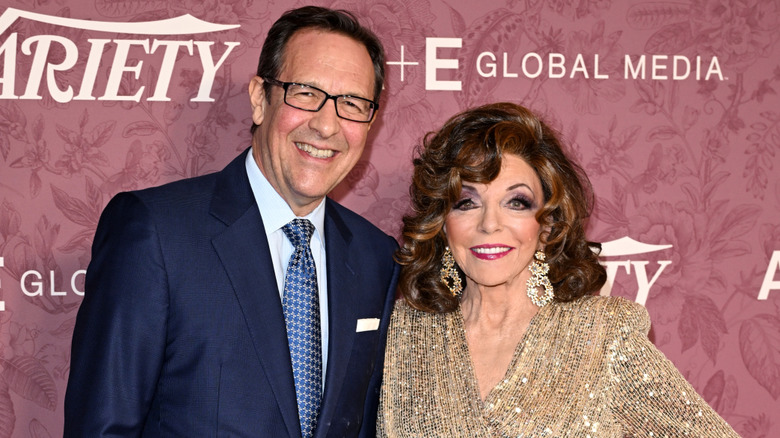 Percy Gibson and Joan Collins smiling