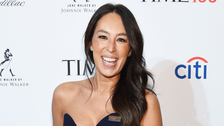 Joanna Gaines smiling and posing at an event.