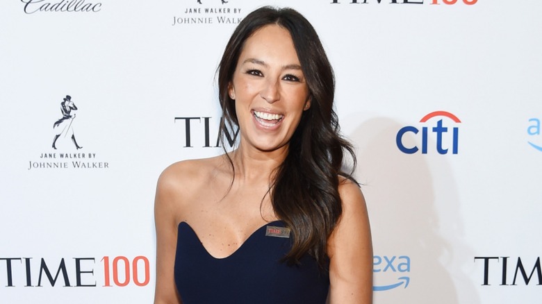 Joanna Gaines smiling wearing a strapless dress