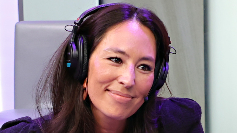 Joanna Gaines wearing headphones and smiling