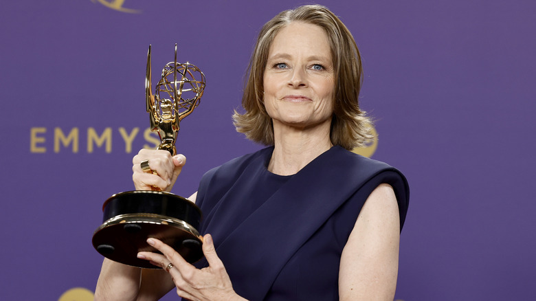 image of Jodie Foster smiling as she holds up an Emmy statue