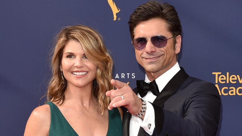 John Stamos pointing next to Lori Loughlin